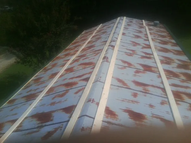 Rusted metal roof panels with new wood purlins before replacement — Storm Damage Roof Repair in North Zulch by Roofing Brothers