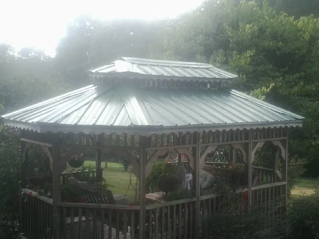 Two tier green metal roof on a garden gazebo in North Zulch